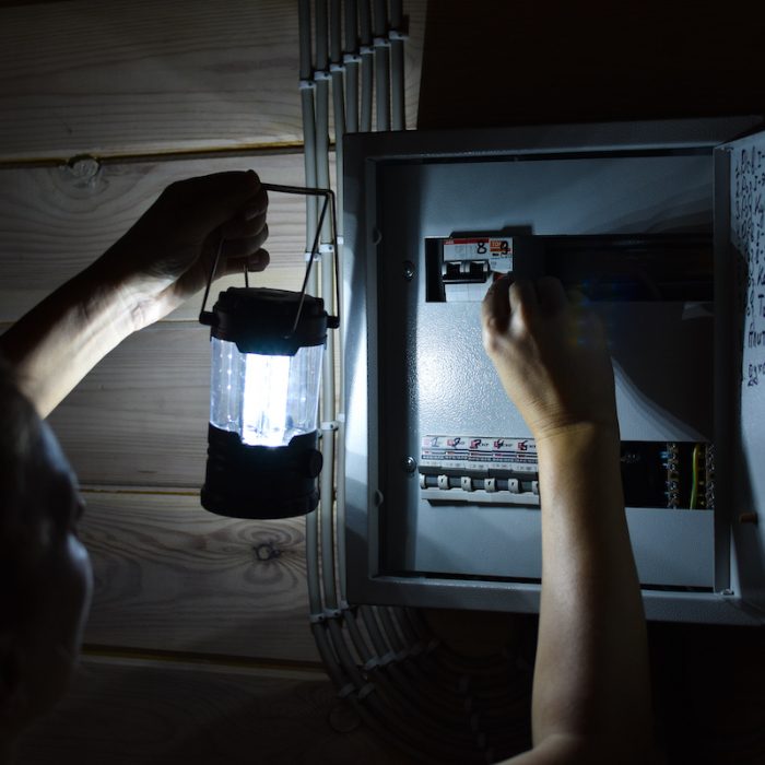 emergency power outage in the house. woman with a flashlight loo